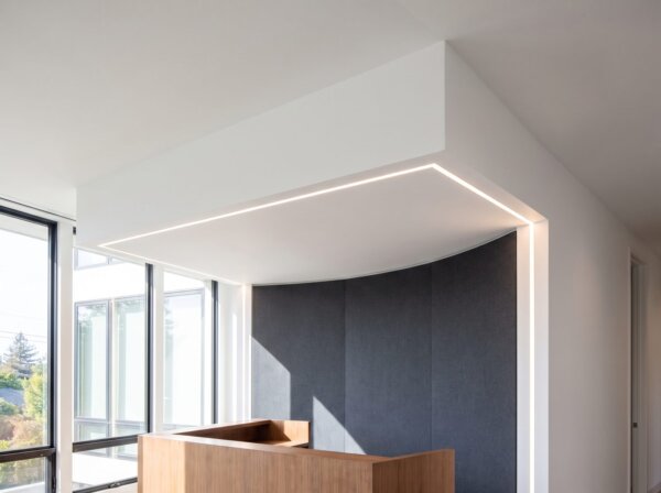 Finished drywall bulkhead and soffit with razor-straight lines over a reception area